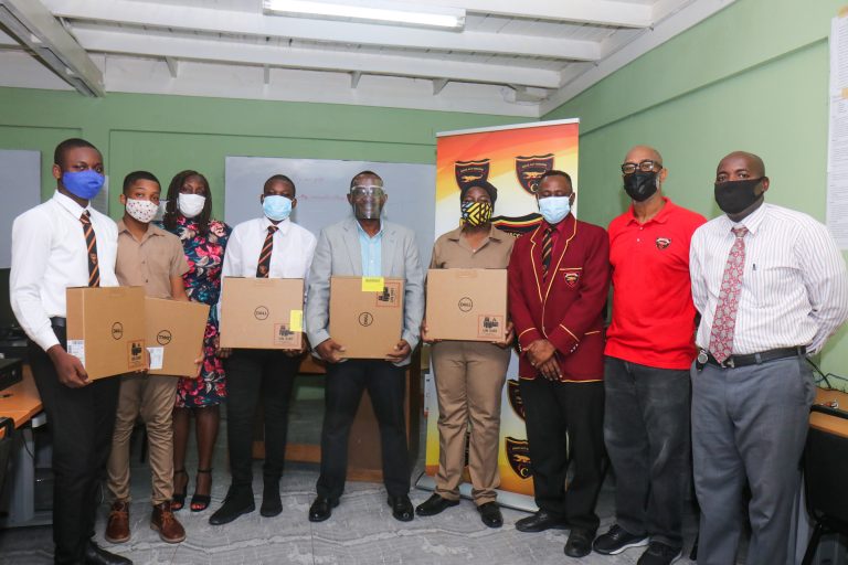 Mr. Michael Ellis, Principal of Cornwall College  (center) flanked by students and other representatives receiving the well needed machines. 